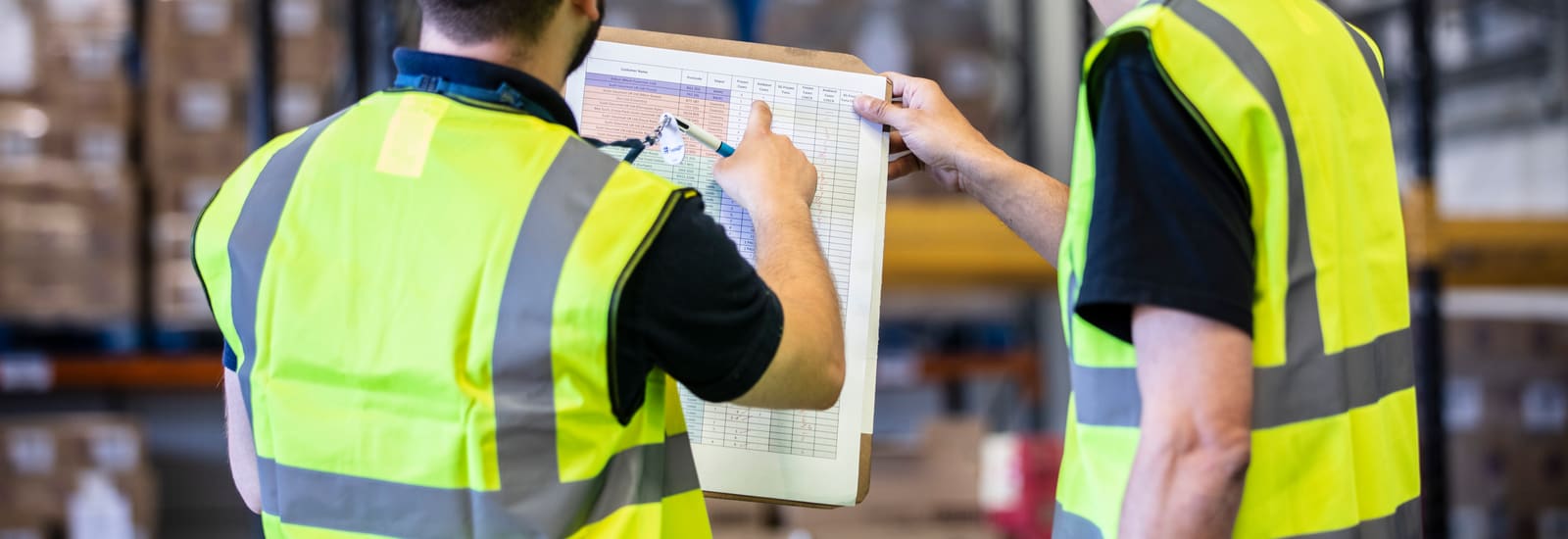 Two Igloo warehouse colleagues checking a pick sheet against the racking